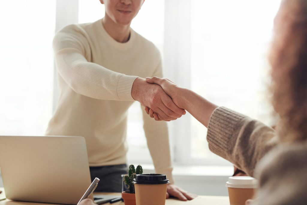 Professional handshake in an office setting, symbolizing partnership and trust, relevant to IRS audit representation services by Liberty Financial Solutions.