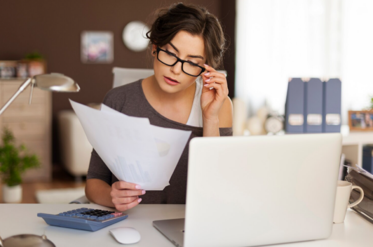 Professional reviewing tax documents and financial statements at a desk in Arlington, TX.